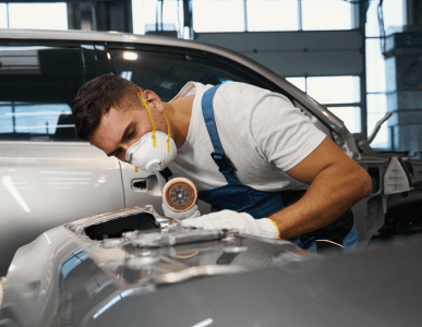 Technician preparing a vehicle panel